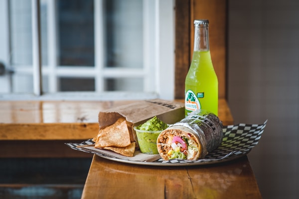 The pulled pork burrito, with guacamole, is one of the best seller at Tejano BBQ Burrito